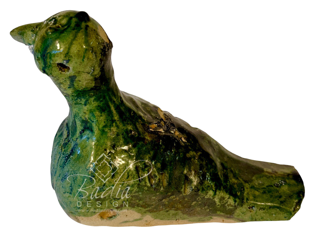 A handmade ceramic bird figurine with a glossy green and blue glaze, featuring a textured, rustic finish. A white watermark for &