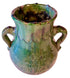 A handmade ceramic planter pot with two side handles, featuring a rustic glaze with green, blue, and brown tones, on a white background.