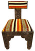 A carved wooden chair with a striped woven seat and backrest, featuring geometric patterns on the wooden frame and colorful stripes in orange, yellow, cream, and brown.