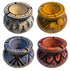 Four hand-painted ceramic candle holders arranged in a 2x2 grid, each with a different color scheme and geometric patterns: blue and white, yellow and orange, blue and white, and terracotta red and black. Each pot features a glossy finish and a &