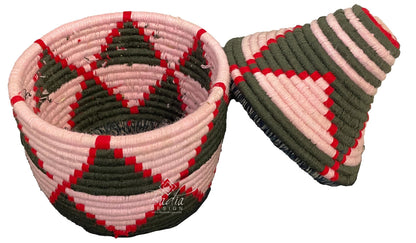 Woven basket with pink and green pattern on a white background
