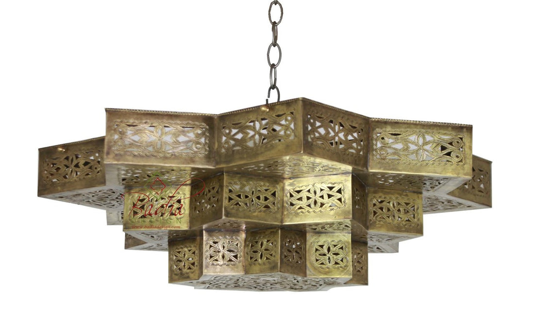 Decorative brass chandelier with intricate patterns on a white background