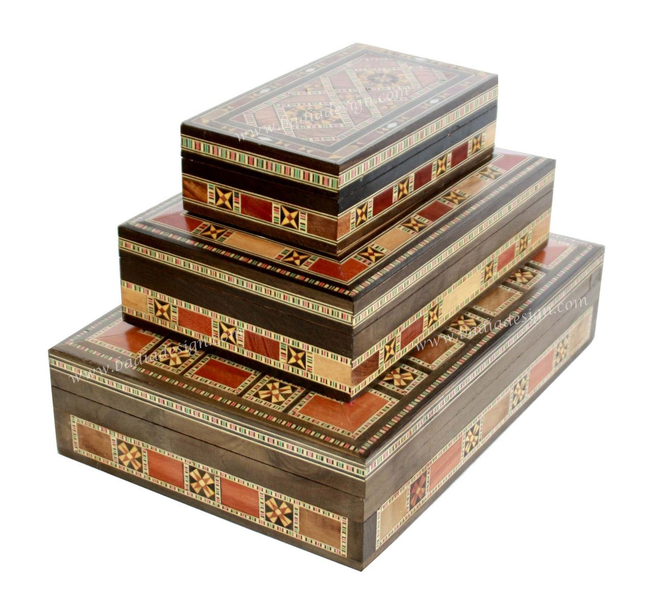 Set of three decorative wooden boxes with intricate patterns on a white background
