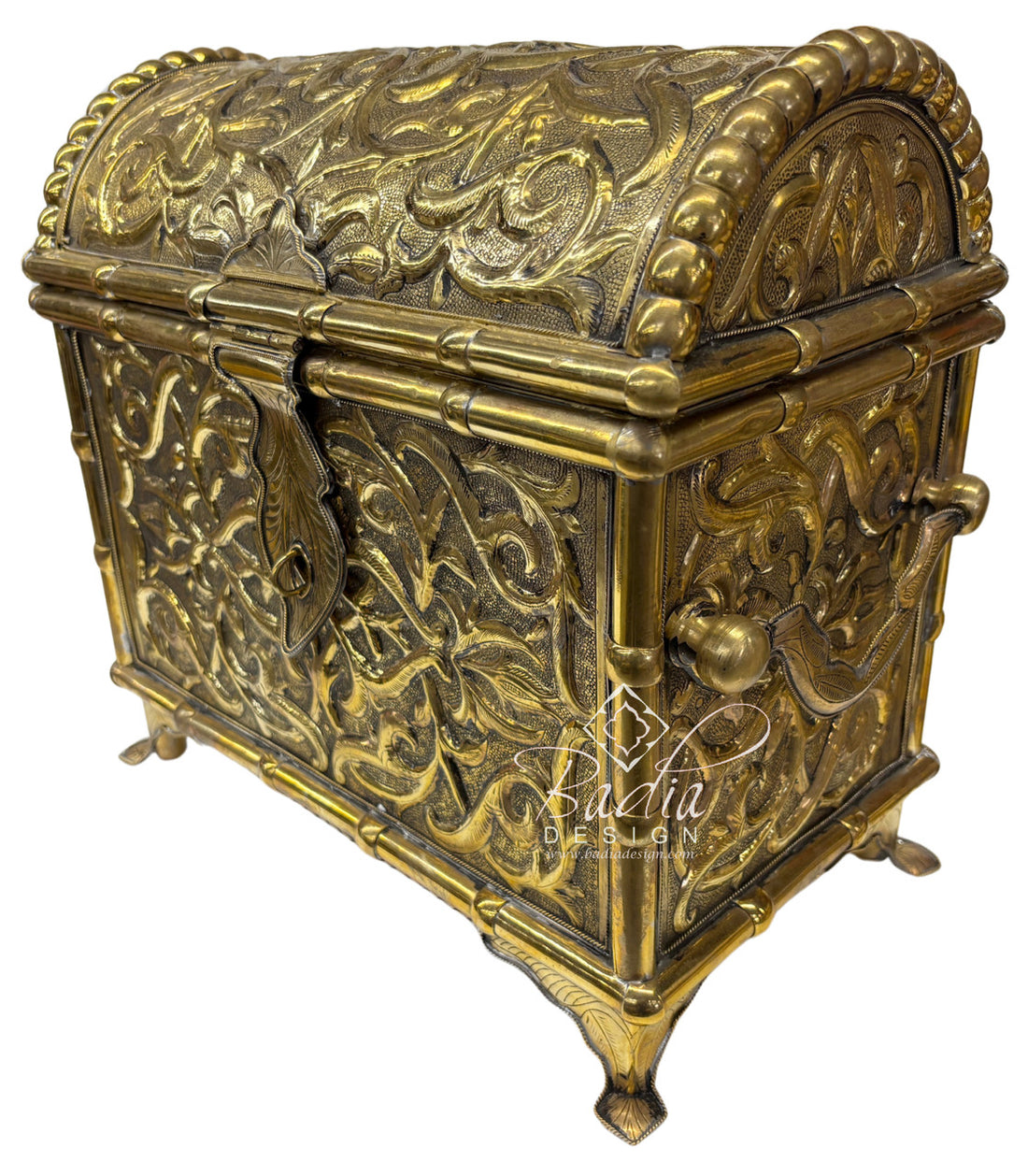 Decorative brass chest with intricate designs on a white background