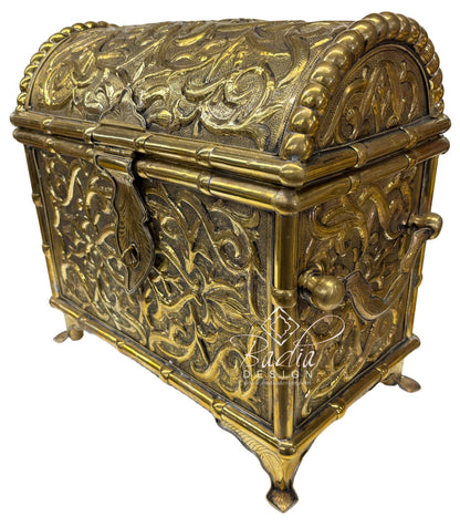 Decorative brass chest with intricate designs on a white background