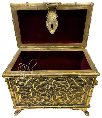 Decorative gold chest with intricate designs on a white background