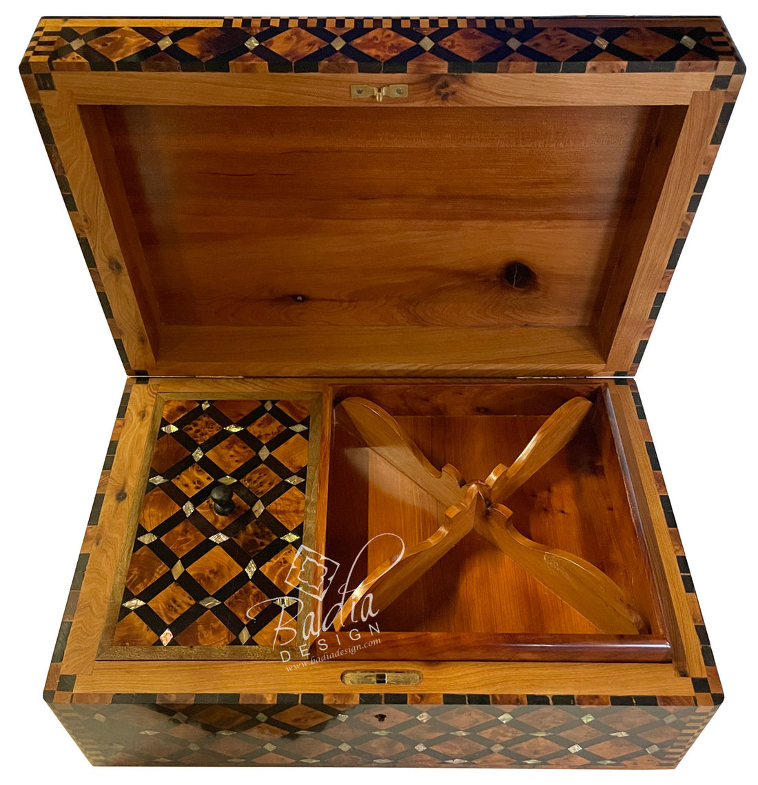 Wooden jewelry box with intricate inlay design and a propeller model inside, branded &