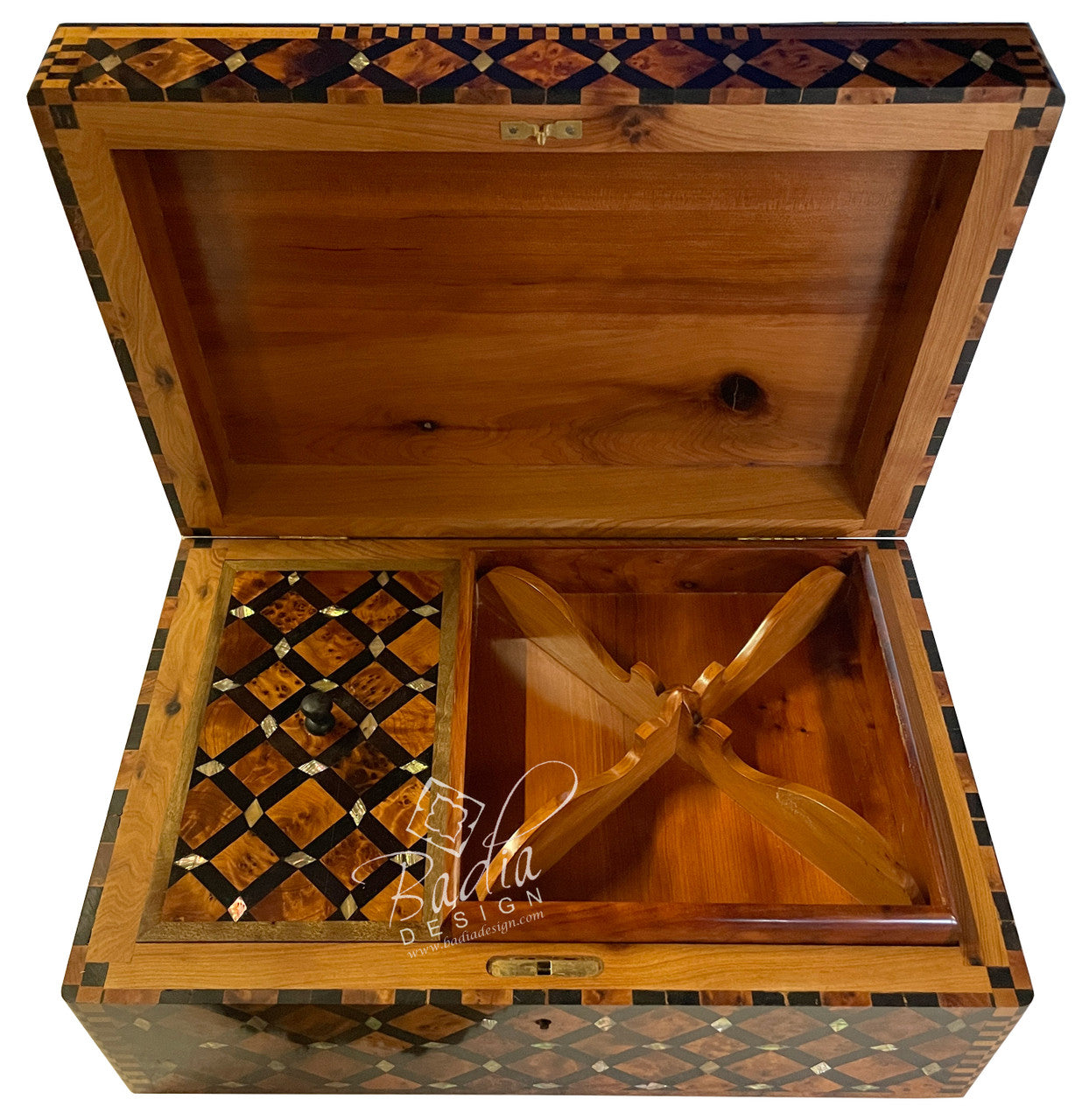Wooden jewelry box with intricate inlay design and a propeller model inside, branded &