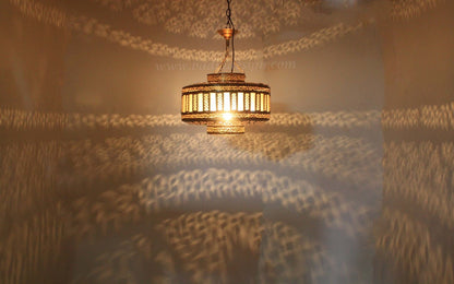 Chandelier casting shadows on a textured wall