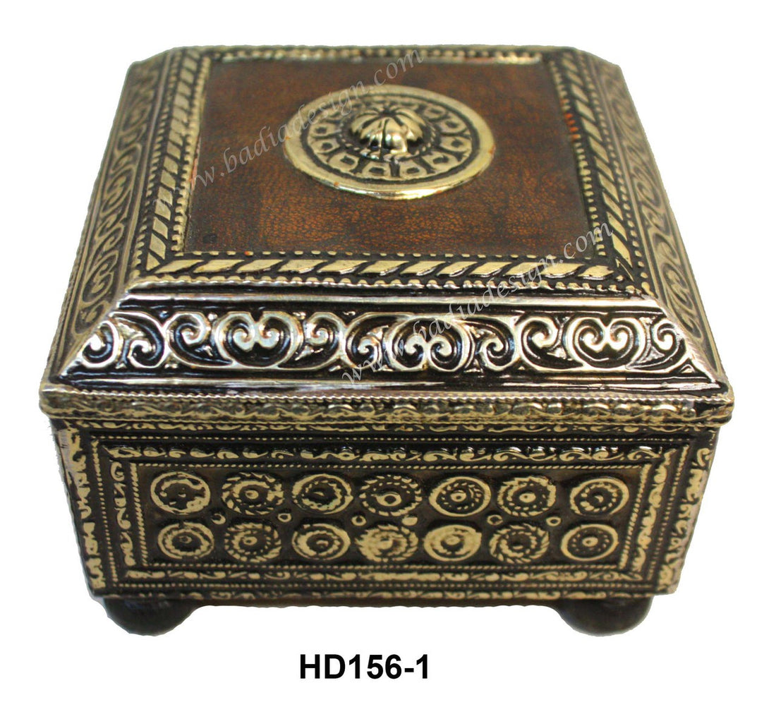 Decorative wooden box with intricate gold patterns on a white background