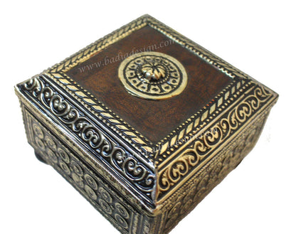 Decorative wooden box with intricate carvings on a white background