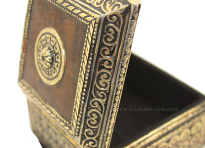 Decorative jewelry box with intricate patterns and a central emblem on a white background
