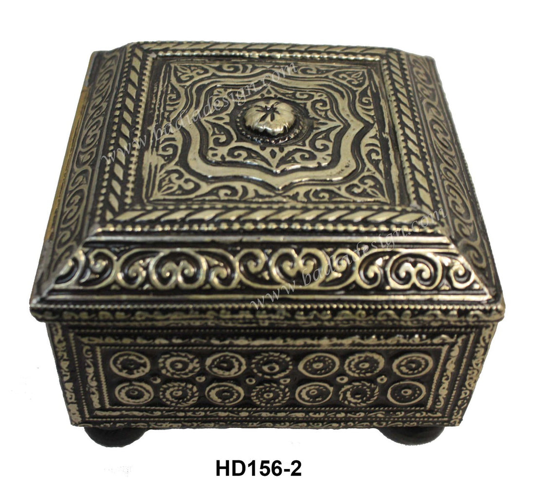 Decorative metal box with intricate patterns on a white background