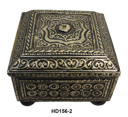 Decorative metal box with intricate patterns on a white background