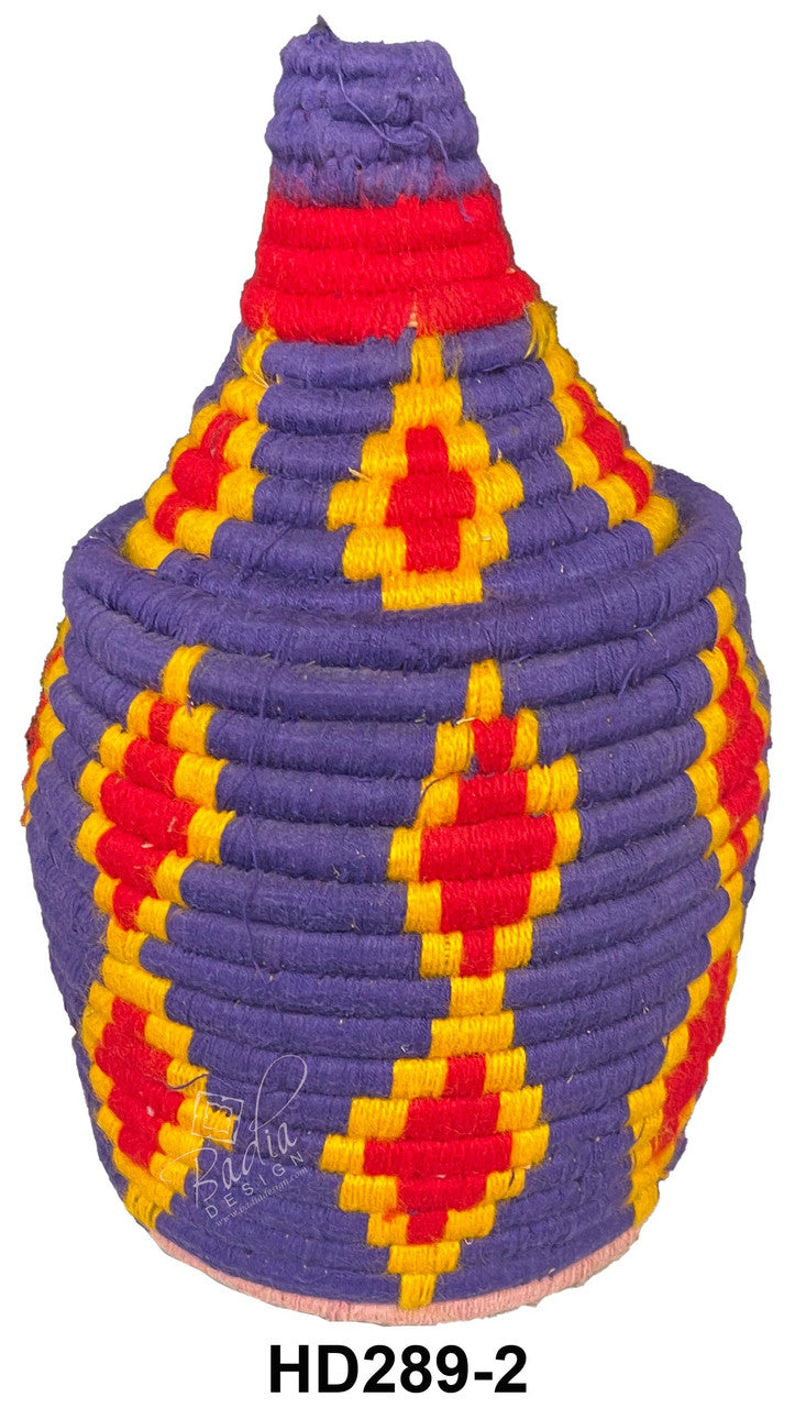 Colorful woven basket with geometric pattern on a white background