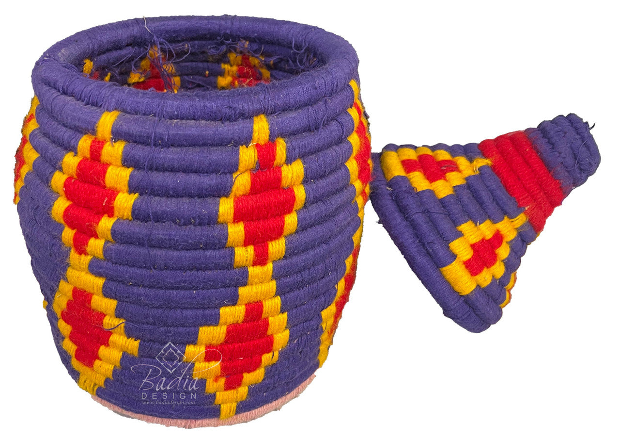 Colorful woven basket with geometric pattern on a white background