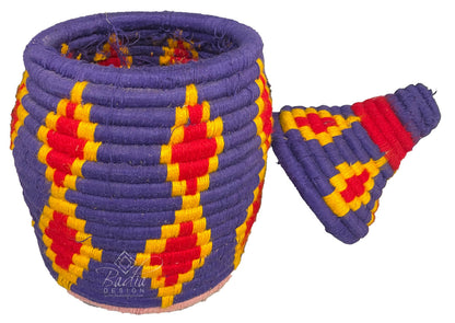 Colorful woven basket with geometric pattern on a white background