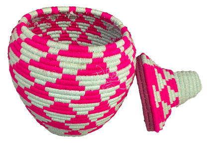Woven basket with pink and white pattern on a white background