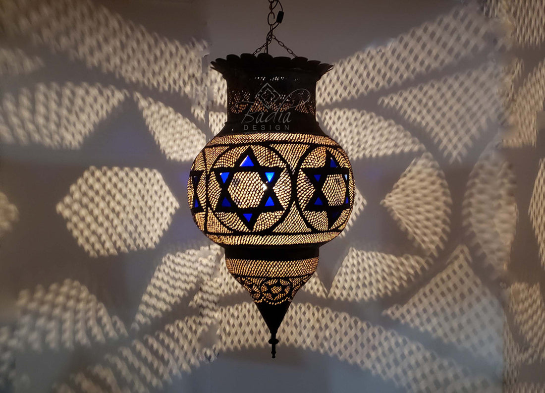 Decorative hanging lamp casting shadows on a textured wall