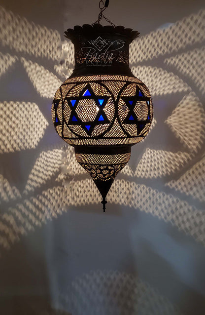 Decorative hanging lamp with star design on a textured wall