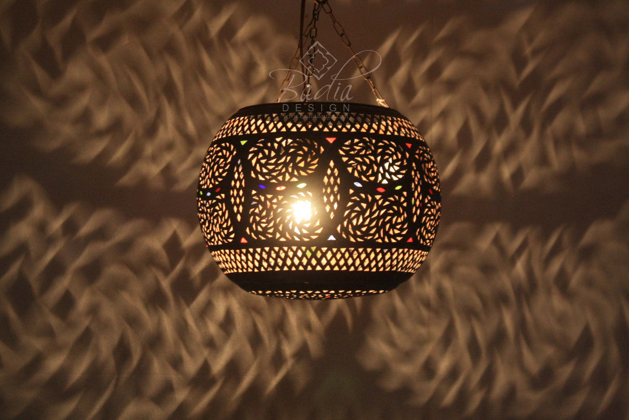 Decorative hanging lamp casting shadows on a textured wall
