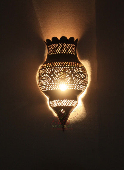 Decorative wall lamp with intricate patterns on a dark background