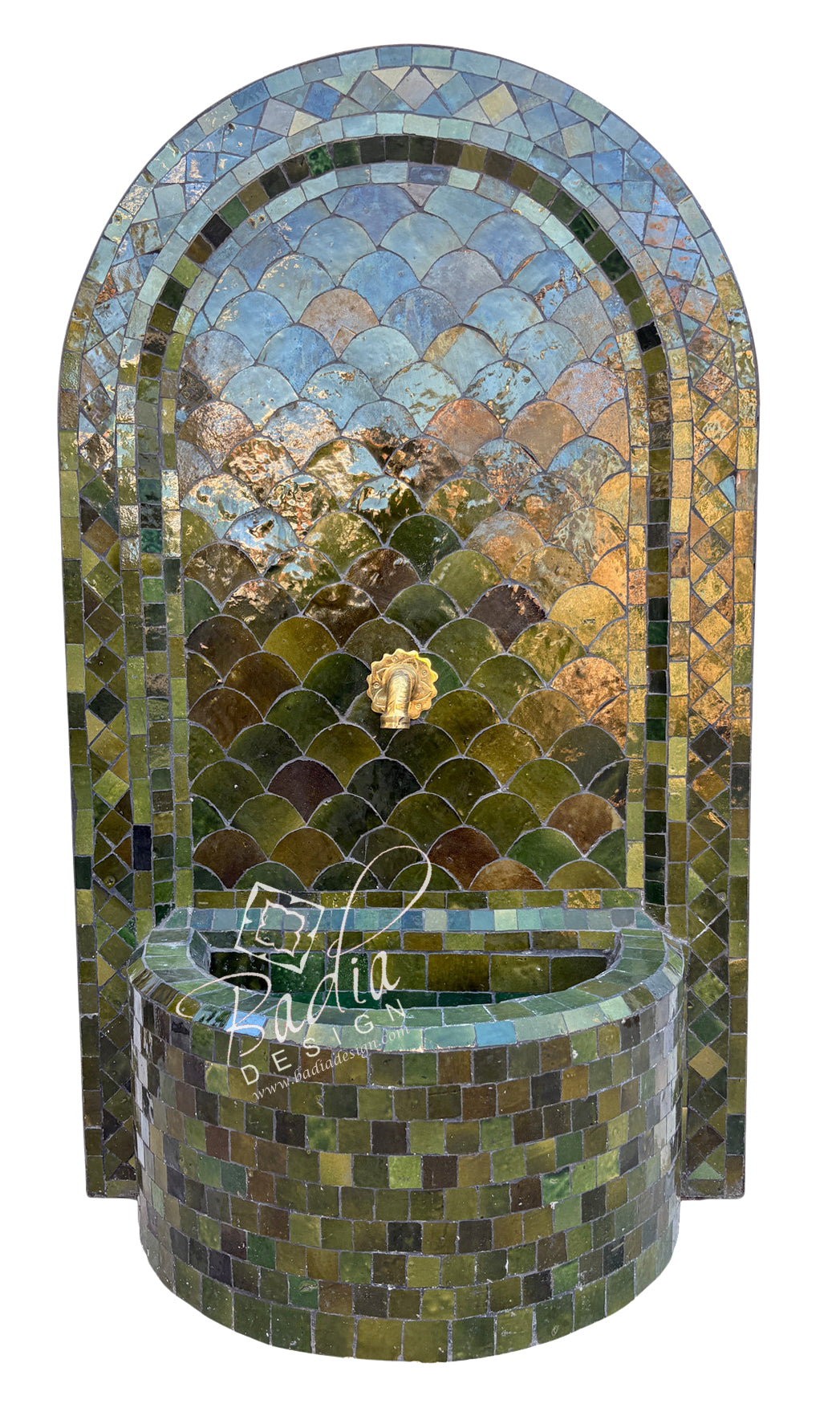 An arched mosaic fountain wall with a matching cylindrical basin, covered in reflective green, blue, and gold tiles. A small lion-head spout is centered near the top.