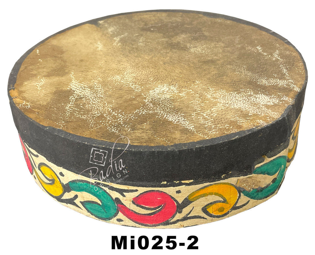Decorative drum with gold surface and colorful patterns on a white background
