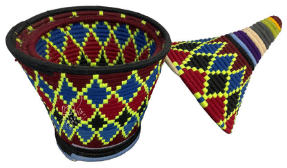 Colorful woven basket with geometric pattern on a white background