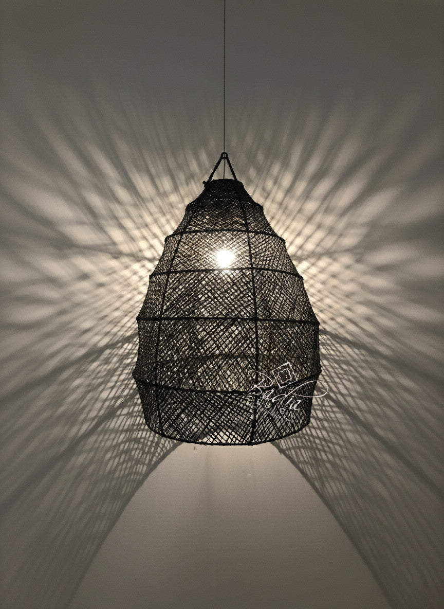 Black woven pendant light casting shadows on a wall