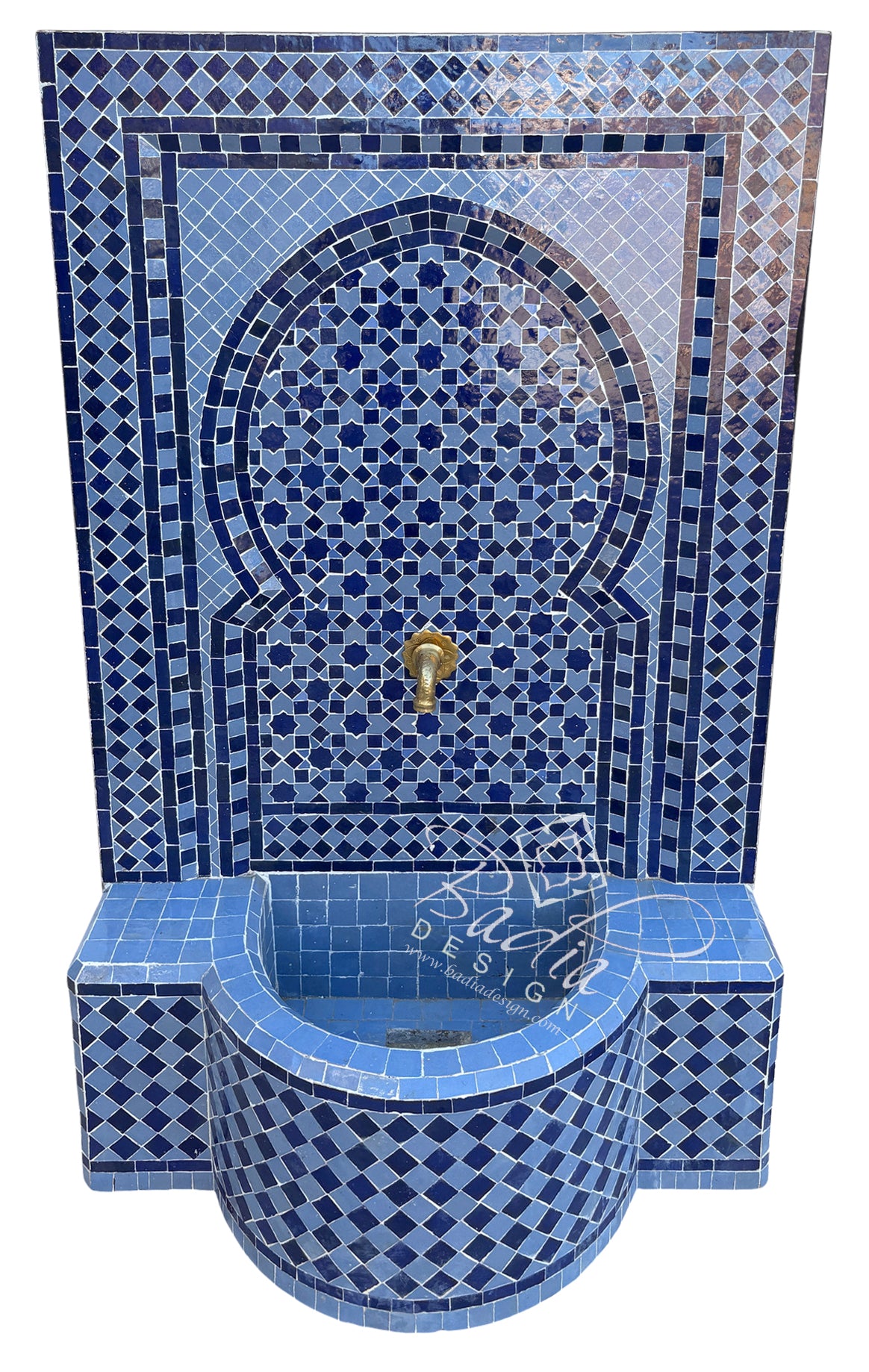 A Moroccan-style mosaic wall fountain with a curved basin, featuring intricate blue and white tile patterns, a central gold faucet, and a white background.