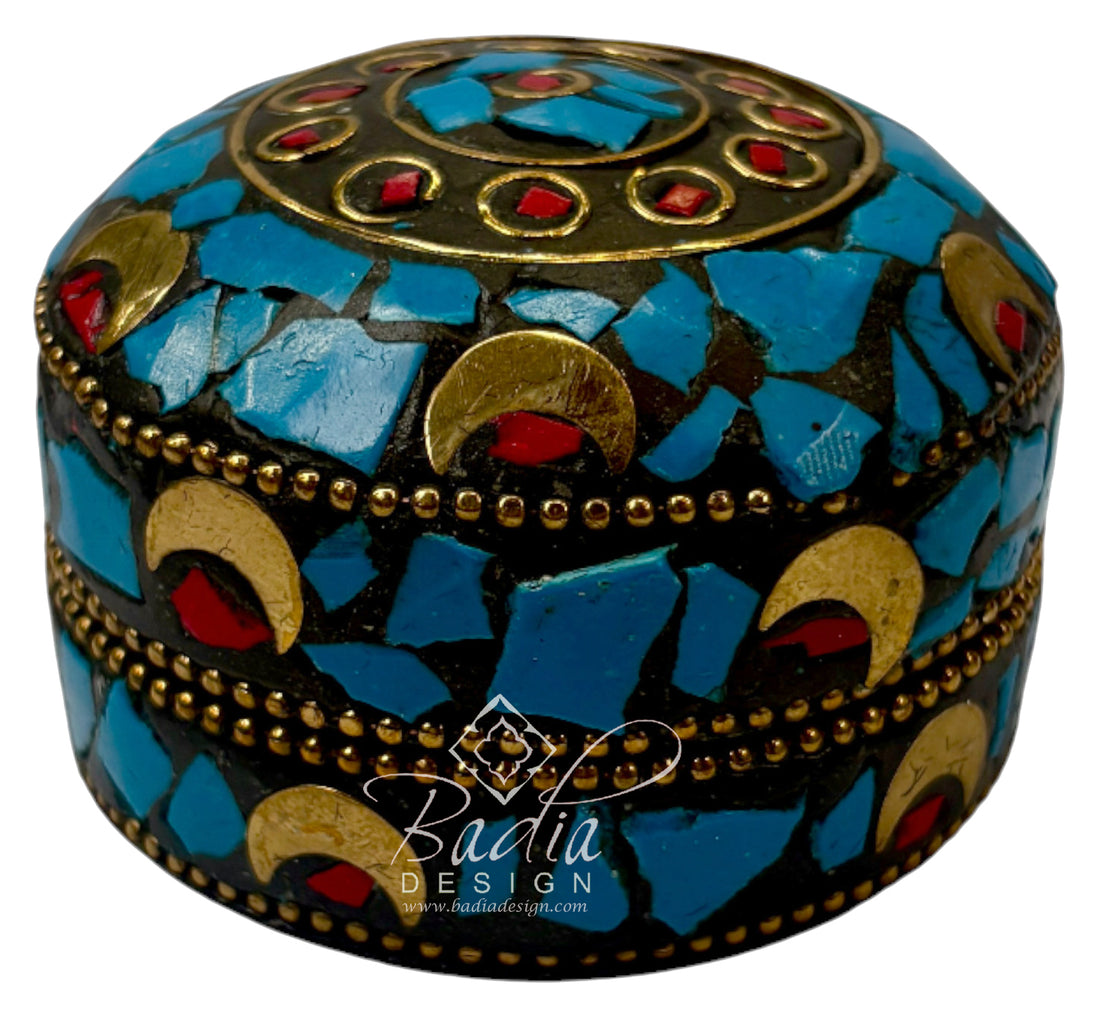 Decorative box with mosaic design featuring blue, gold, and red colors on a white background.