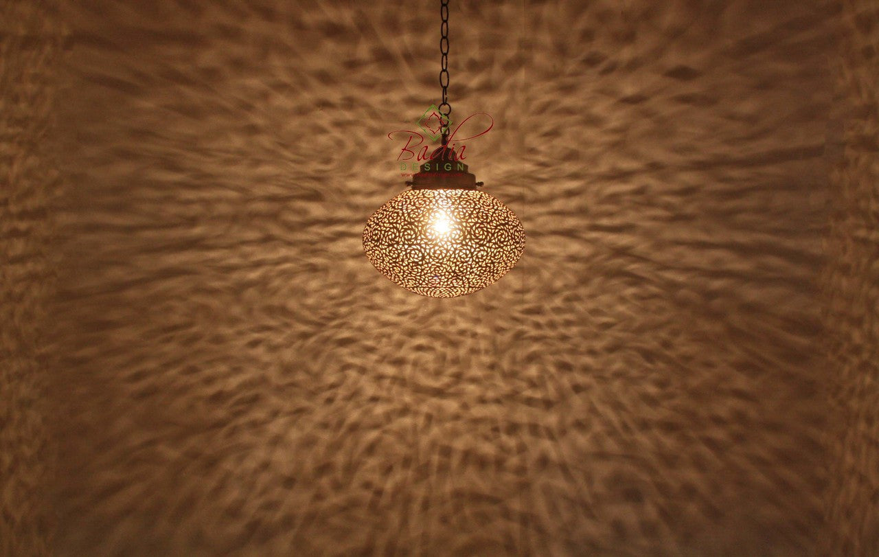 Decorative ceiling light fixture casting a warm glow on a textured wall.