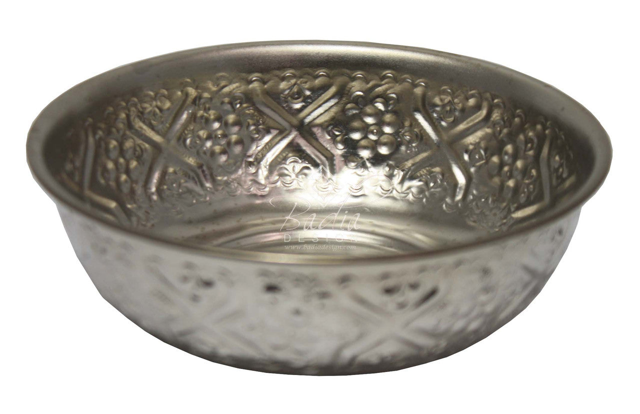 Silver bowl with embossed design on a white background