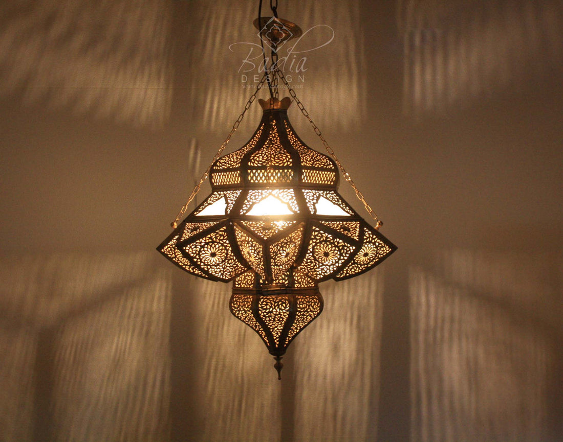Decorative hanging lamp with intricate patterns on a textured wall background