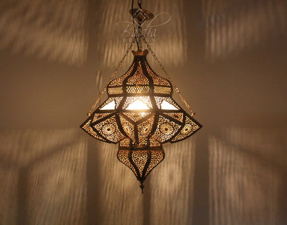 Decorative hanging lamp with intricate patterns on a textured wall background