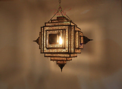 Decorative hanging lamp with intricate design on a plain background