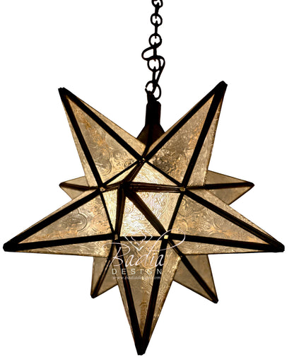 A hanging star-shaped pendant light with textured gold-toned glass panels and dark metal framing, suspended from a black chain against a plain white background.