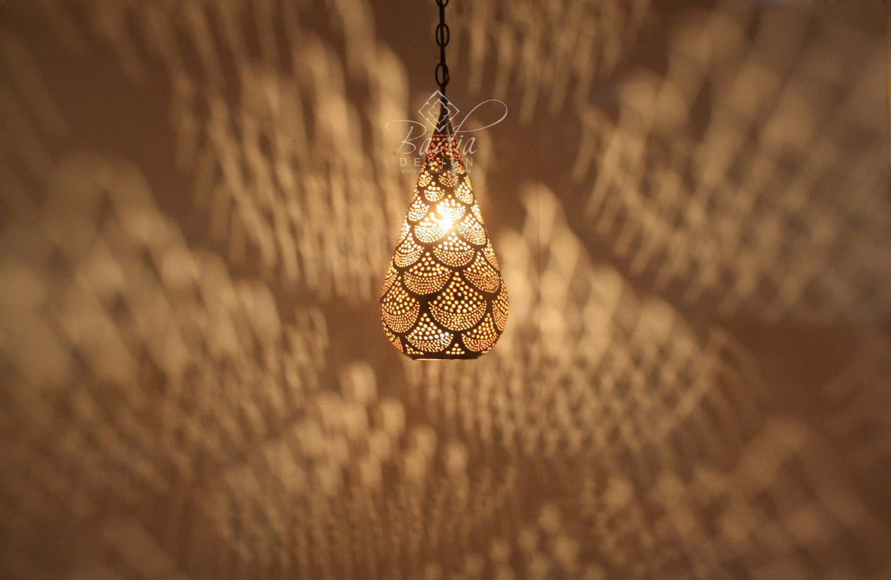 Decorative hanging light fixture casting shadows on a textured wall.