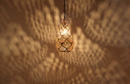 Decorative hanging light fixture casting shadows on a textured wall.