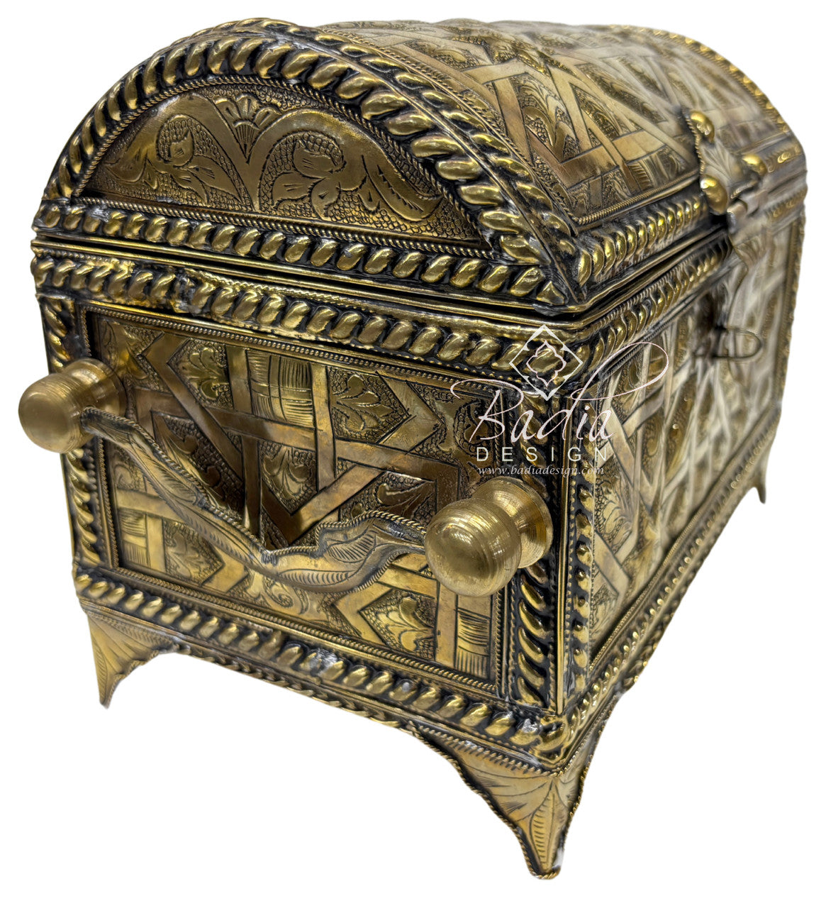 Decorative brass box with intricate designs on a white background