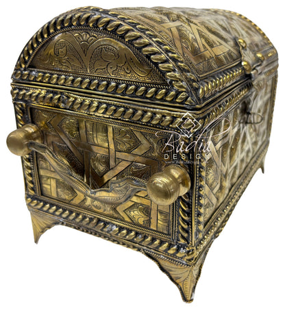 Decorative brass box with intricate designs on a white background