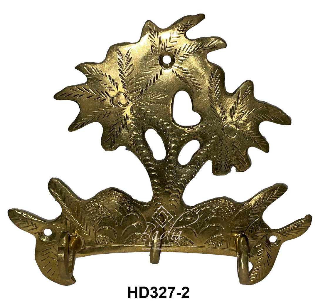 Decorative brass wall hook with floral design on a white background
