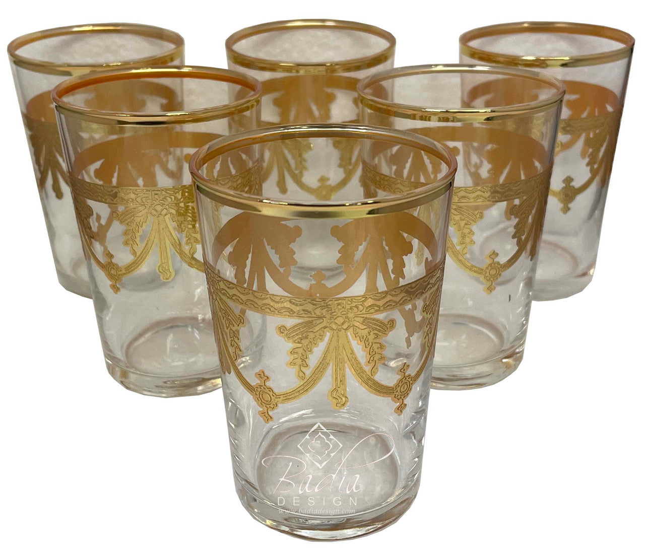 Set of six clear glasses with gold decorative patterns on a white background