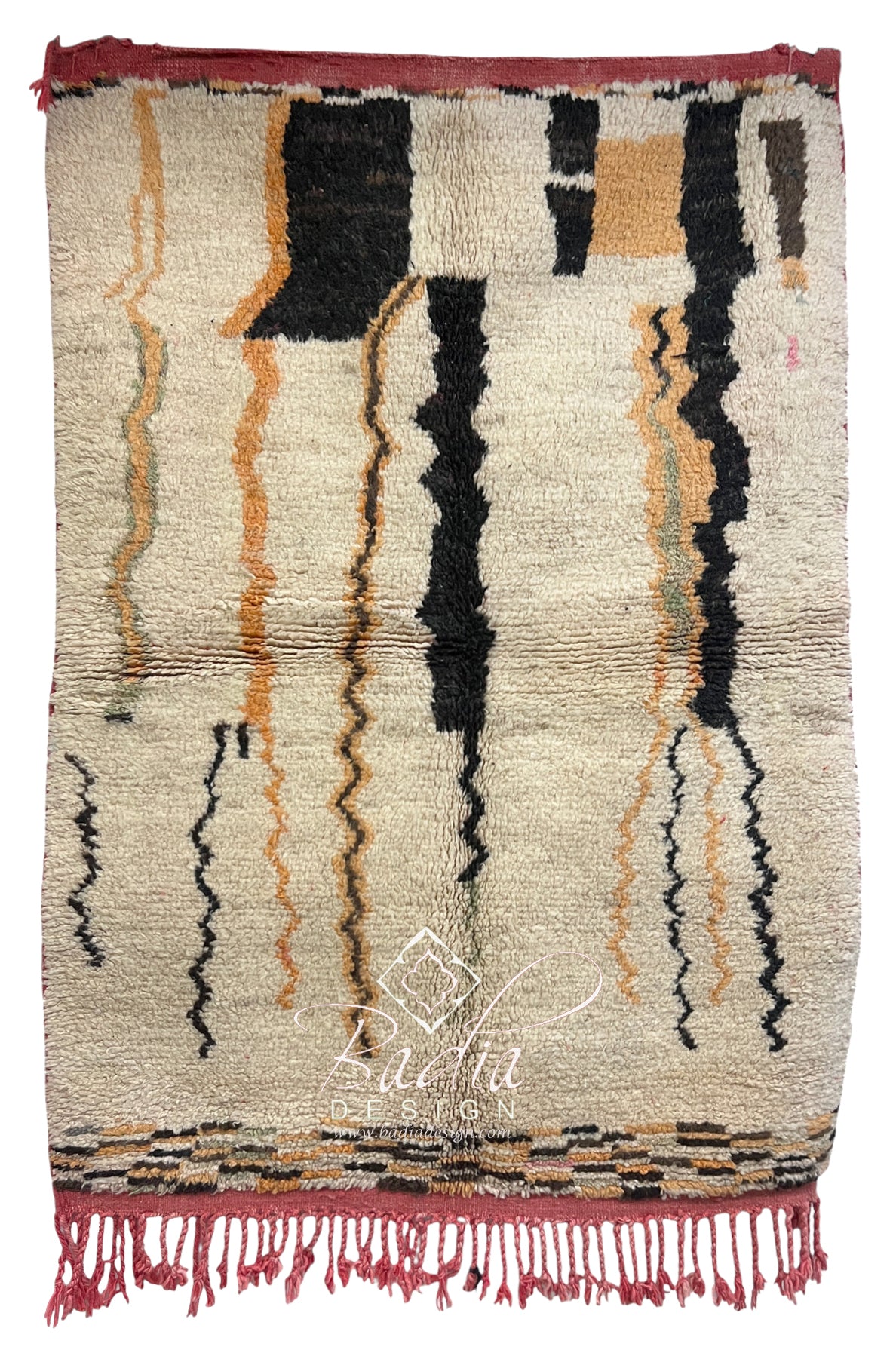 A rectangular hand-woven Moroccan rug with a cream base, featuring vertical black, rust orange, and beige zigzag stripes, finished with a rust red fringed border.
