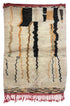 A rectangular hand-woven Moroccan rug with a cream base, featuring vertical black, rust orange, and beige zigzag stripes, finished with a rust red fringed border.