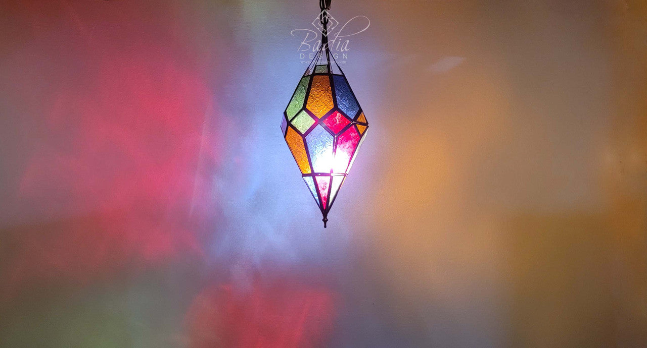 Colorful geometric glass pendant light against a blurred background