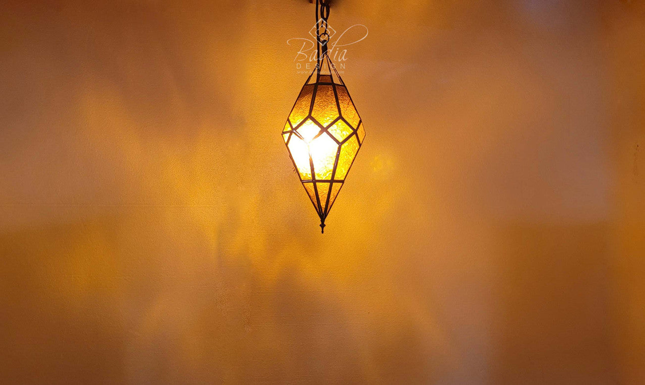 Decorative hanging lamp with a warm glow against a blurred background