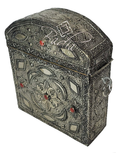Decorative jewelry box with intricate patterns and red stones on a white background
