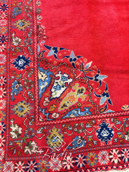 Deep Red Rug with Geometric and Floral Designs